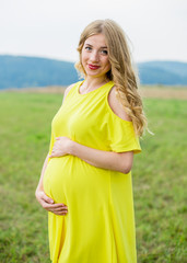 Portrait of a young and beautiful pregnant smiling at the camera