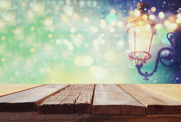 Empty table in front of abstract Christmas street lights