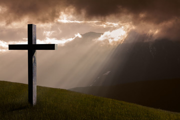 Jesus Christ cross. Christian wooden cross on a background with dramatic light, mountains, colorful...