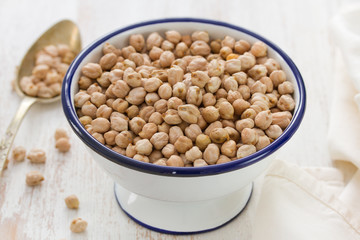 chick pea in white bowl on wooden background