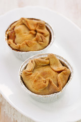 portuguese chicken cookies on white dish on wooden background