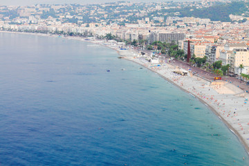 cityscape of Nice with stone beach and sea, France