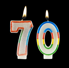 Burning birthday candles on black, number 70