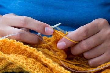 Close up of woman hands knitting colorful wool yarn