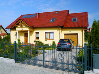 Yellow residential dwelling with red roof in Poland