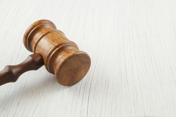 Judge gavel on white table with room for text