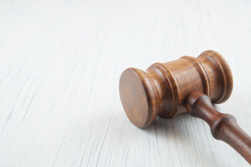 Judge gavel on white table with room for text