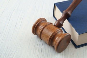 Judge wooden gavel and legal book on white table with space for text