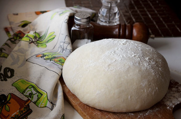 Yeast dough lying on the board.
