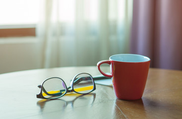 Work desk with glasses, Red coffee cup