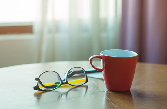 Work desk with glasses, Red coffee cup