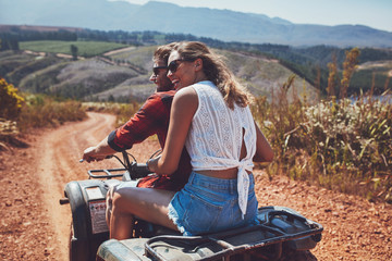 Young happy couple cruising on a quad vehicle © Jacob Lund