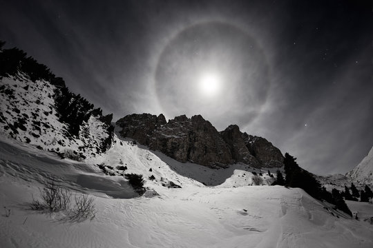 Full moon with halo in Small Almaty Gorge, Tian Shan mountains, Kazakhstan