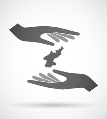 Obraz premium Isolated pair of hands protecting or giving the map of North Ko