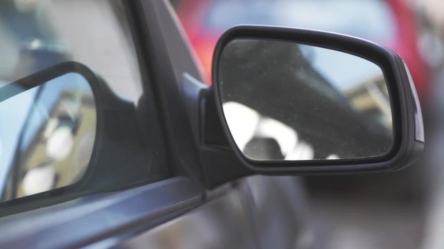 Close up footage of an automatic side mirror being adjusted.