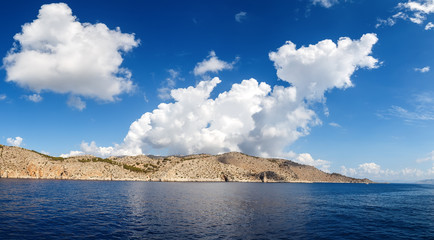 view of the island in the Aegean sea, clouds, Sunny summer day