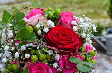 Bridal flowers with pink and red roses at the wedding day