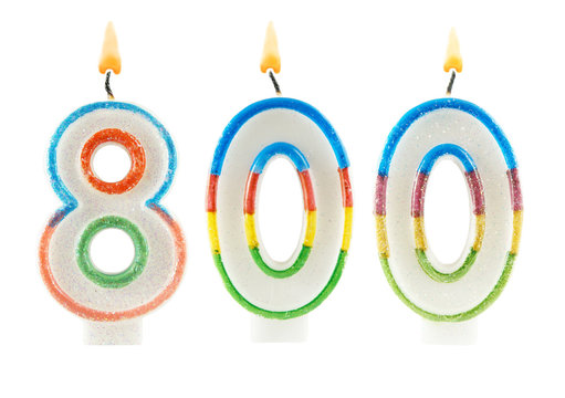 Burning birthday candles isolated on white background, number 800