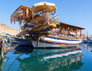 Fototapeta na wymiar Seashells shop boat in the harbour of Rhodes, Dodecanese, Greece