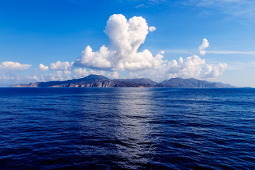 cloud in shape of heart over the island in sea, Sunny summer weather, Greece, Aegean