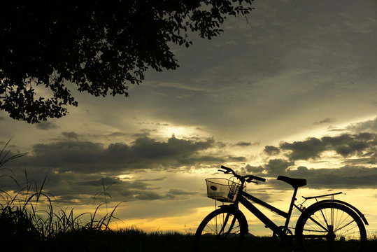 bicycle sillouette at sunset nature background
