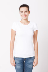 T-shirt design and people concept - close up of young woman in blank white t-shirt. Clean shirt mock up for design