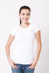 Obraz premium T-shirt design and people concept - close up of young woman in blank white t-shirt. Clean shirt mock up for design