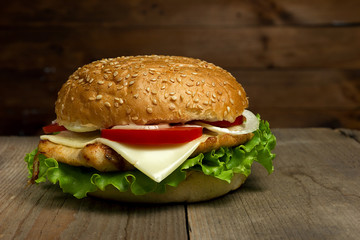Home made hamburger on wooden background. Fastfood meal.