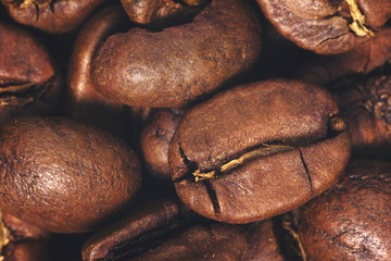 Coffee beans closeup on natural texture. Vintage toned