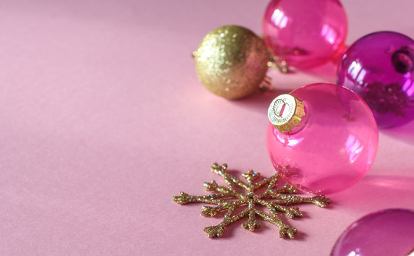 Christmas Decoration On Pink Background. Closeup Of Pink And Gold Christmas Balls