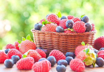 Fresh berries (raspberries, blueberries, strawberries) in basket © Maresol