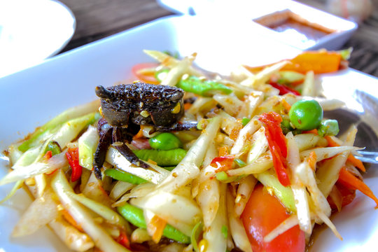 Pickled crab salad or Papaya salad on table(Som tum),Green Papay