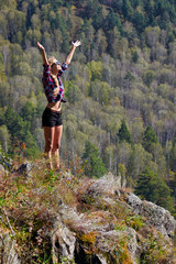 Naklejka premium Young blonde woman tourist on a cliff over the river Berd