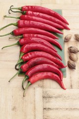 Fresh red hot chilli on wood background.