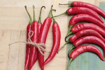 Fresh red hot chilli on wood background.