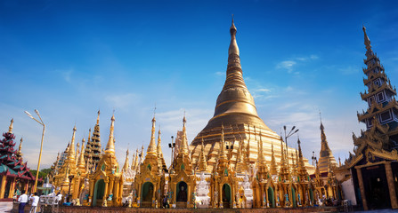 Fototapeta premium Amazing architecture of Shwedagon or Great Dagon Pagoda. Most sacred Buddhist place with relics of four past Buddhas. Yangon, Myanmar (Burma) travel landscapes and destinations. Ten images panorama