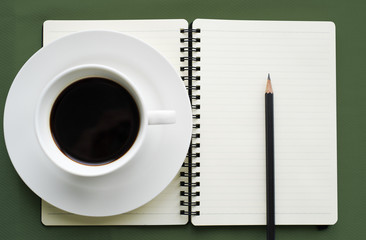 Coffee in white cup with Journal book and pencil