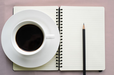 Coffee in white cup with Journal book and pencil