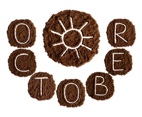 October and sun, decorated with ground coffee on white background