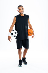Cheerful african sports man holding basketball and soccer ball