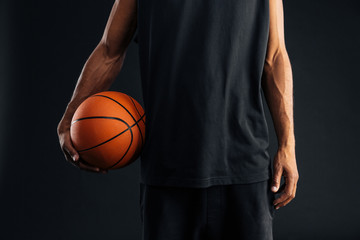 Cropped image of an african basketball player holding ball