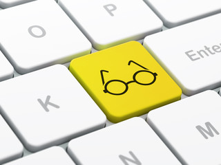 Science concept: Glasses on computer keyboard background