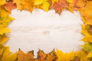 Naklejka na ściany i meble Autumn Leaves over wooden background 