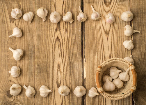 garlic in a basket on a wooden table