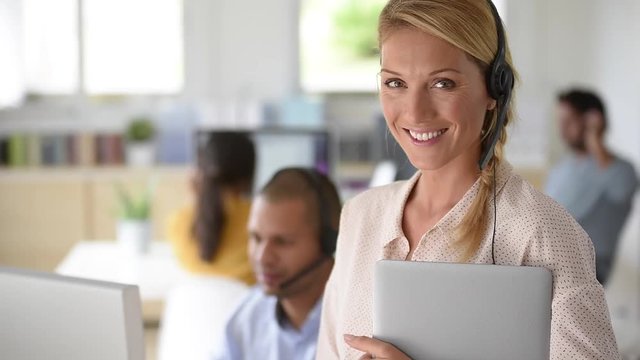 Closeup of customer service manager standing in call center