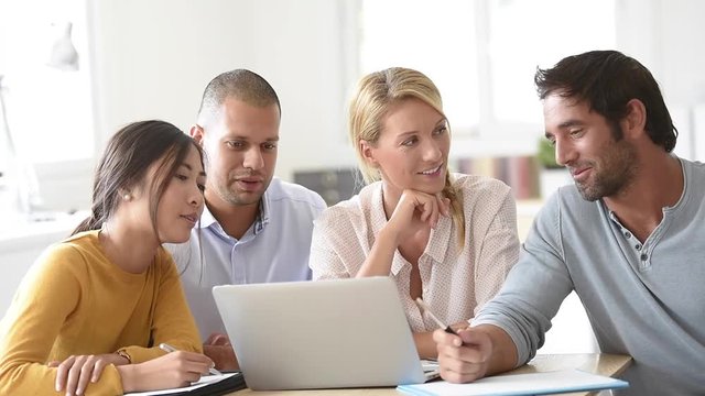Business workgroup interacting in office