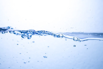 Closeup water wave and air bubbles in water.