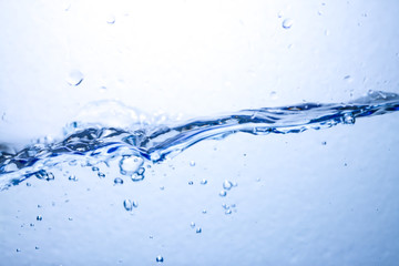 Closeup water wave and air bubbles in water.