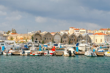Fototapeta na wymiar Chania. Fishing boats and yachts in the harbor.