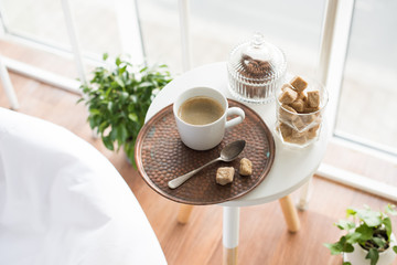 Coffee with sweets served on table in cozy loft room